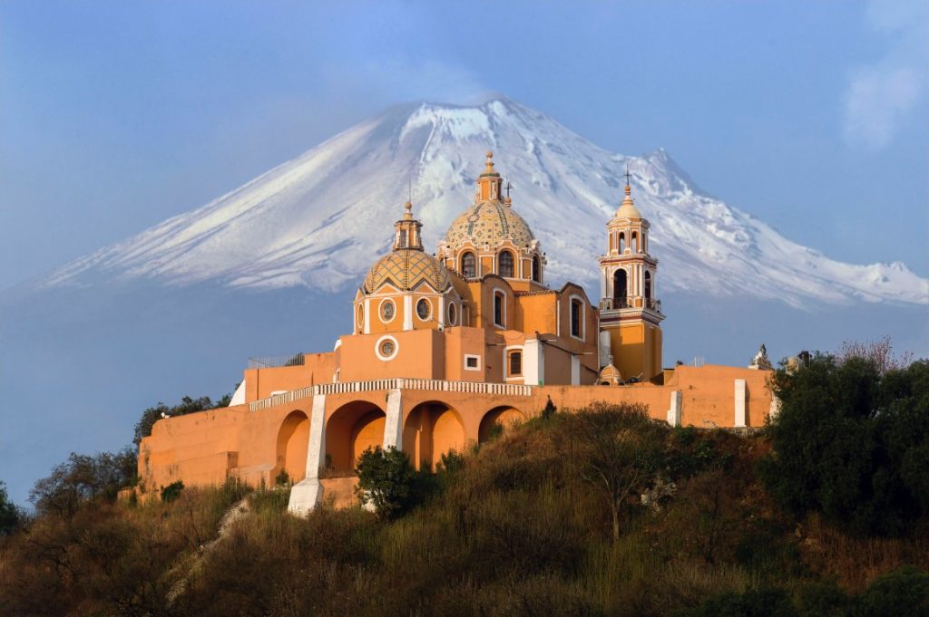 The pyramid of Cholula, with the Popocatépetl volcano in the background