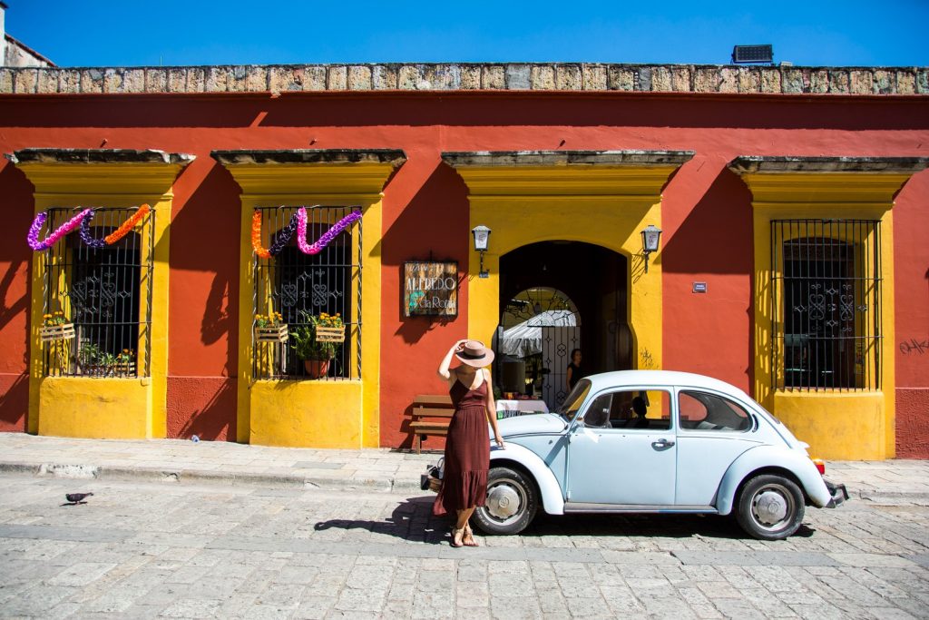 Woman standing in front of a car in Oaxaca, one of the best places in Mexico for digital nomads.