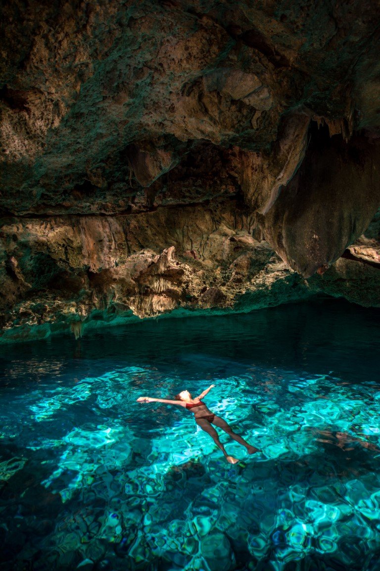 Woman floating at Cenote Dos Ojos.