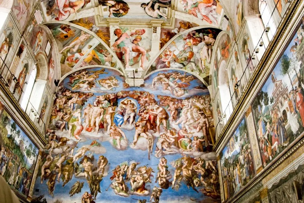 A ceiling covered in colorful frescoes,  inserted in a post about Sistine Chapel Tickets