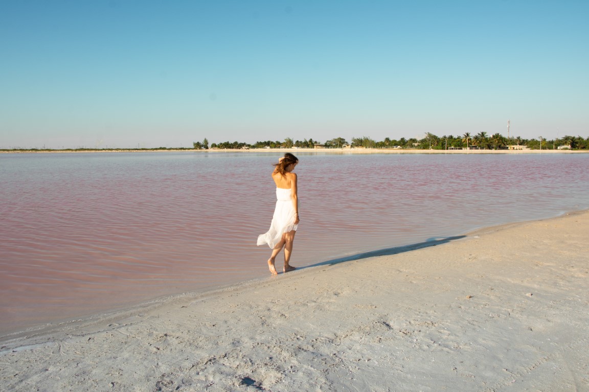Woman walking next to the Las Coloradas pink lakes in Yucatan, Mexico