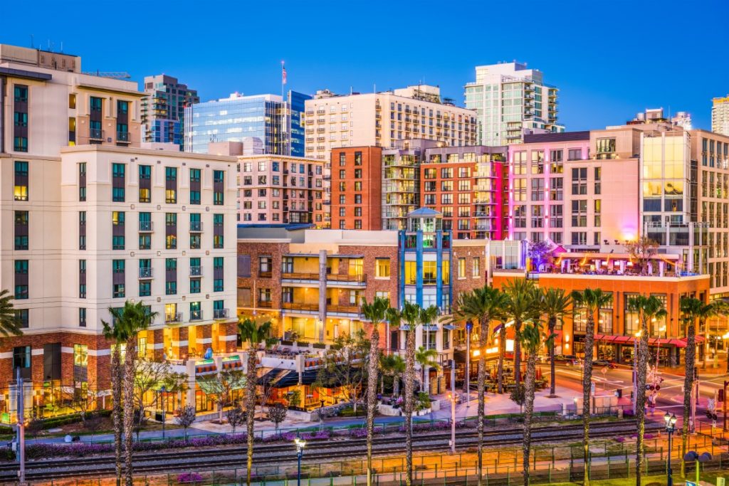 An image of Downtown San Diego, with  its buildings lit up for the evening. Inserted in a post about Palm Springs day trips 