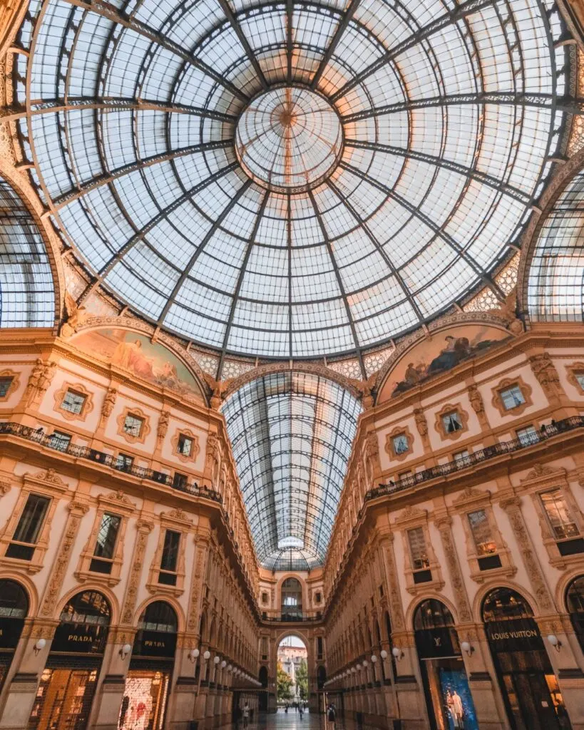 The elegant interiors of Galleria Vittorio Emanuele II, featuring an iron and glass roof