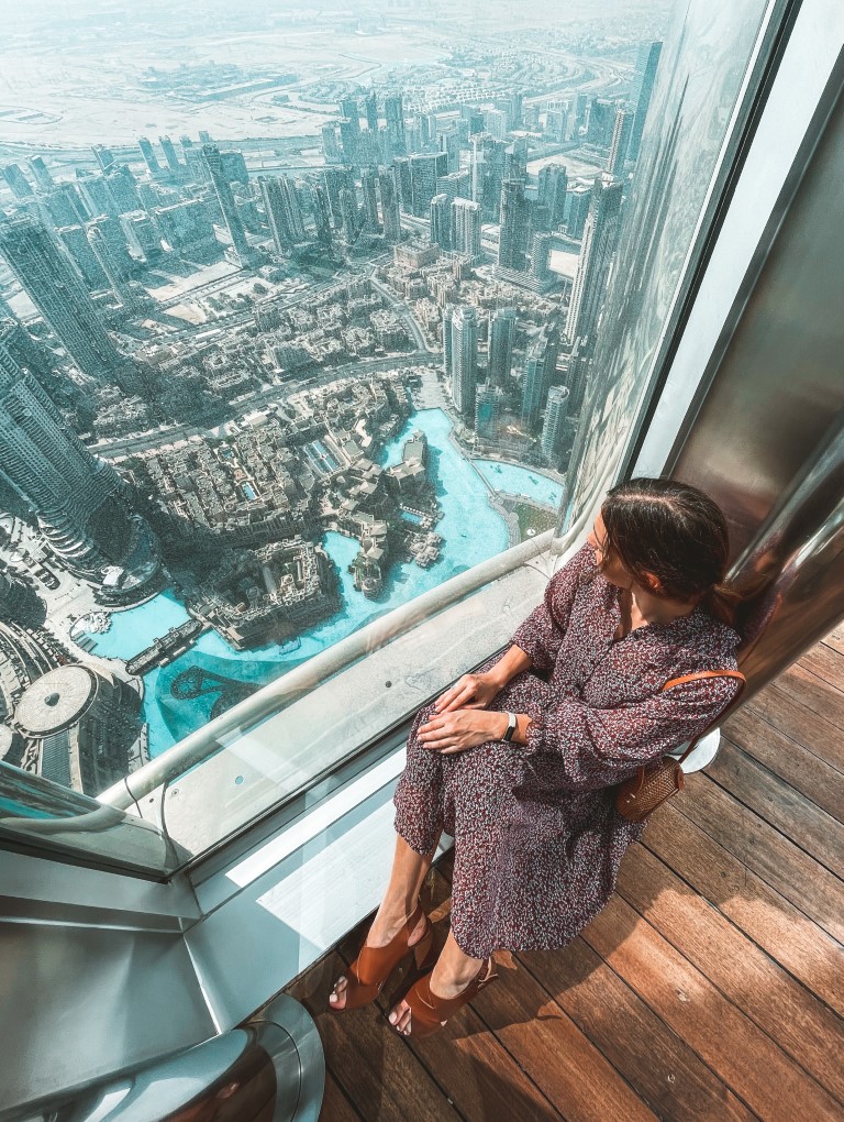 Woman on top of the Burj Khalifa - visiting the Burj Khalifa is one of the best things to do in Dubai.