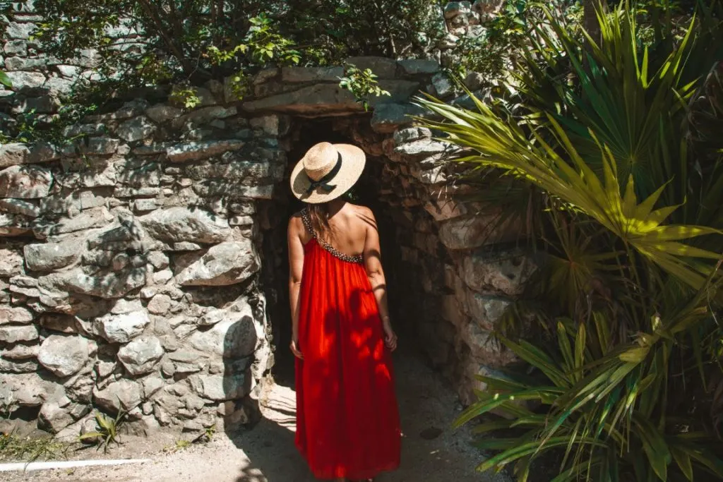 Woman in front of one of the structures of the Tulum ruins.