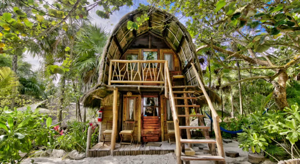 An image of a cabin in Ahau Tulum, surrounded by vegetation