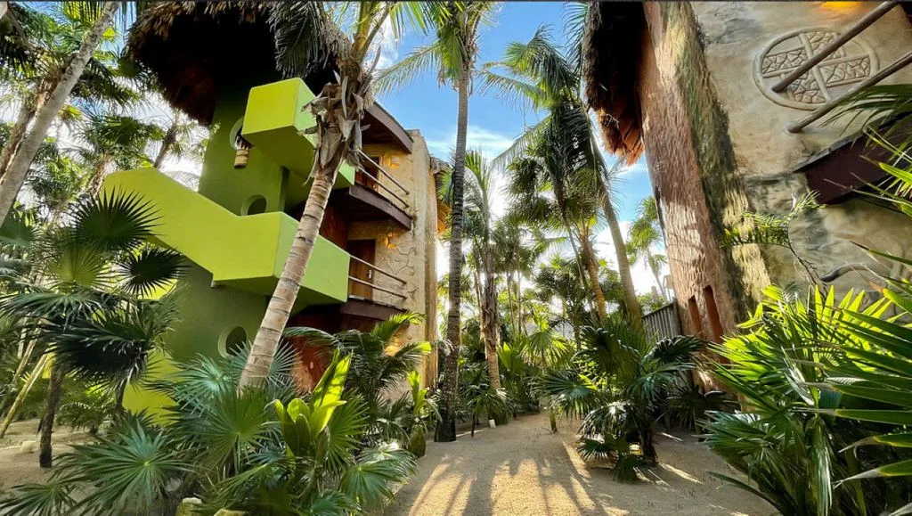 An image of Sueños Tulum,  surrounded by palm trees, inserted in a post about eco resorts in Tulum