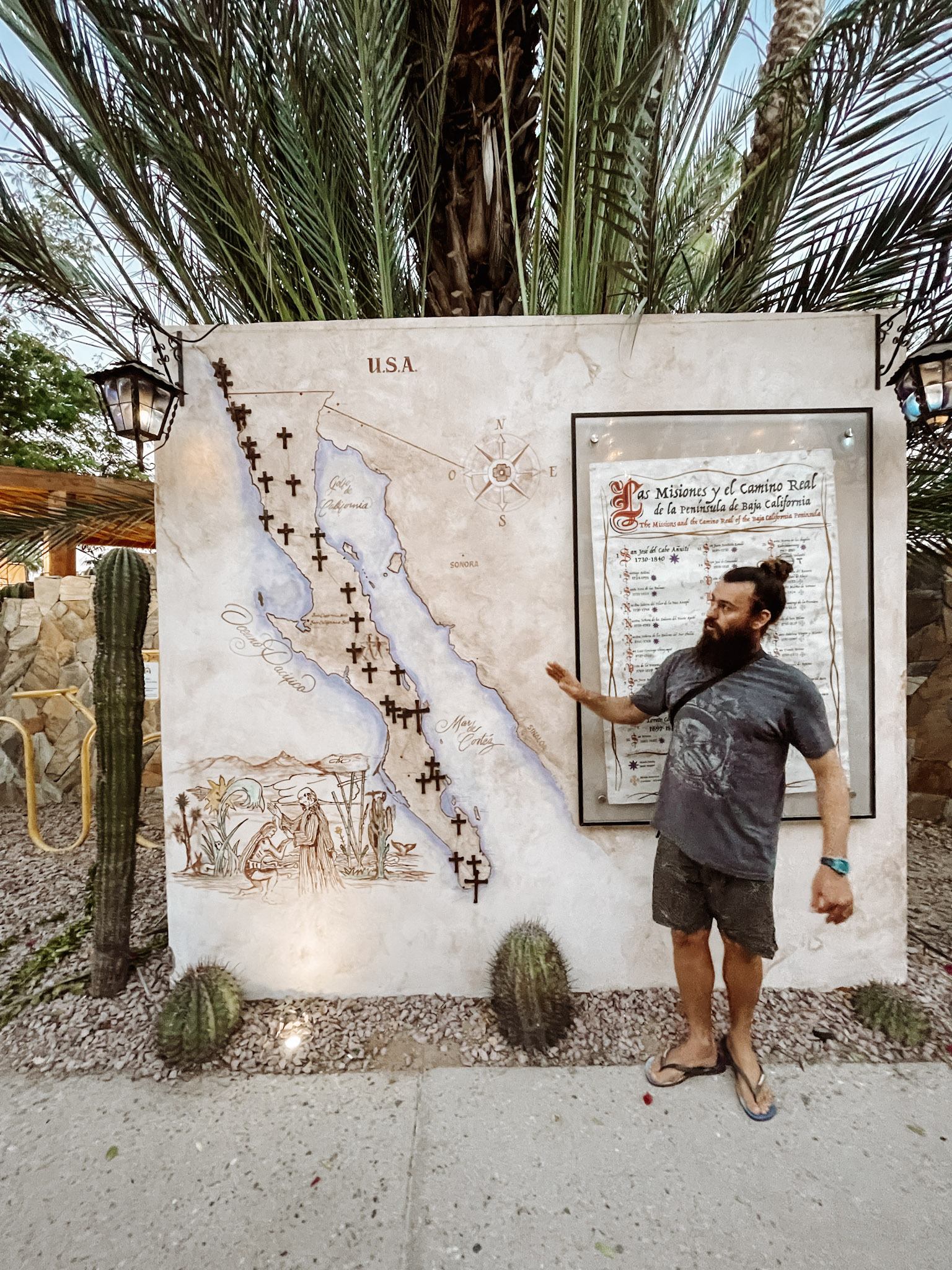 A guide pointing at a map during a city tour in Los Cabos