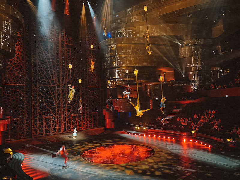 A stage with artists flying and doing acrobatic stunts at La Perle Dubai