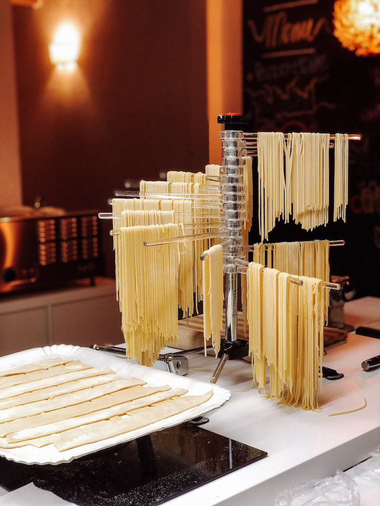 Fresh pasta hanging to dry - making fresh pasta in an essential part of all the best Florence cooking classes.