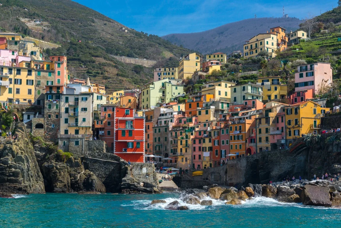 Colorful houses in Manarola, one of the Cinque Terre villages, perched on rocky cliffs above the Ligurian Sea.
