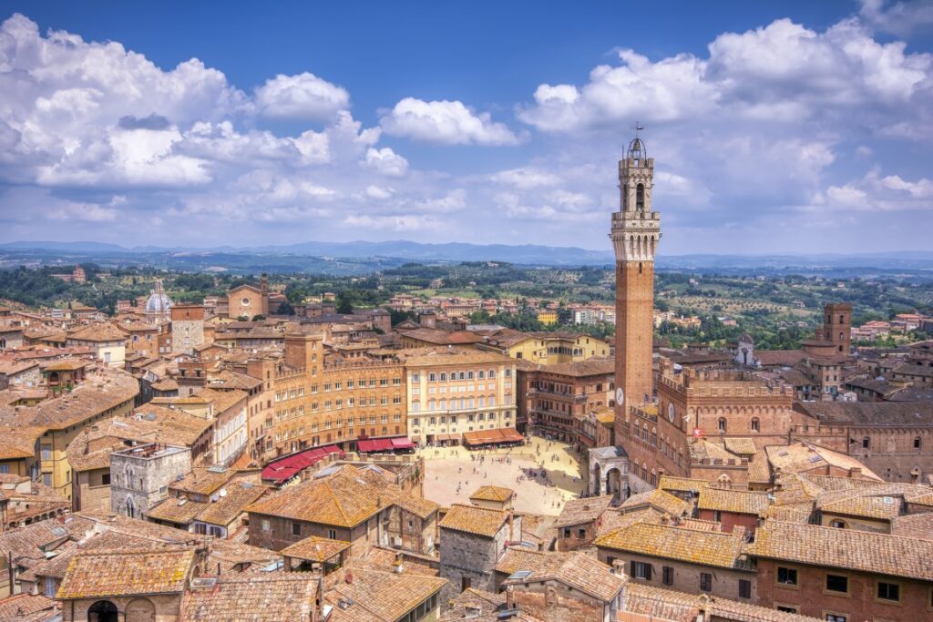 Image of Piazza del Campo with the Mangia tower  seen from above, in an article about Siena Tours from Florence
