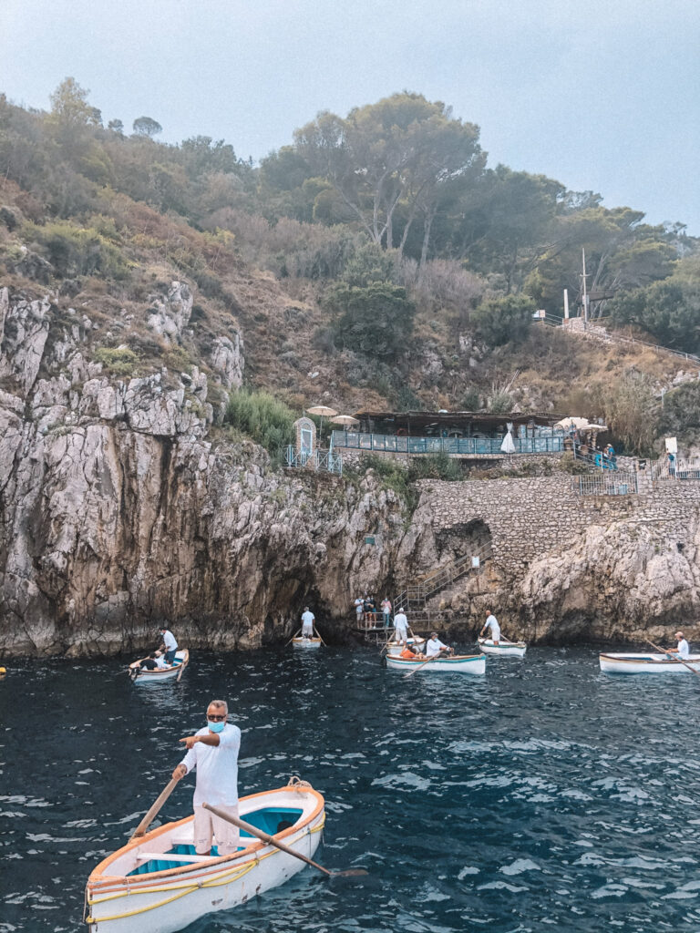 private tour positano to capri Image of boats at the entrance of the Blue Grotto, which many Capri boat tours from Positano visit.