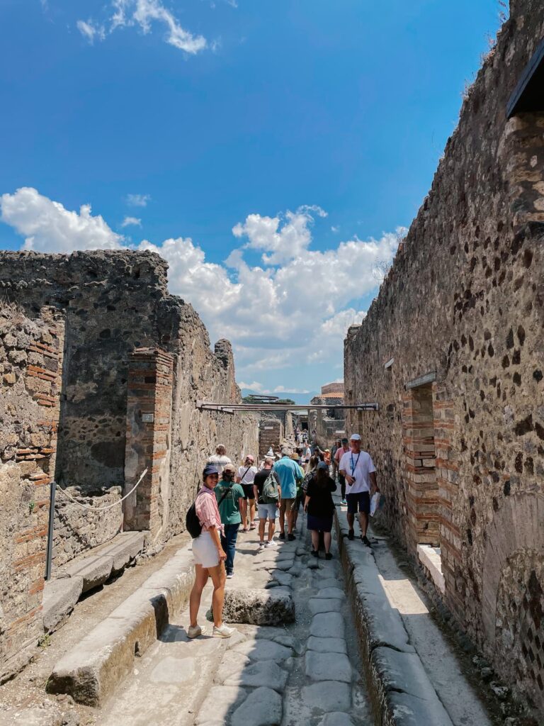 Tourists exploring the ancient ruins of Pompeii