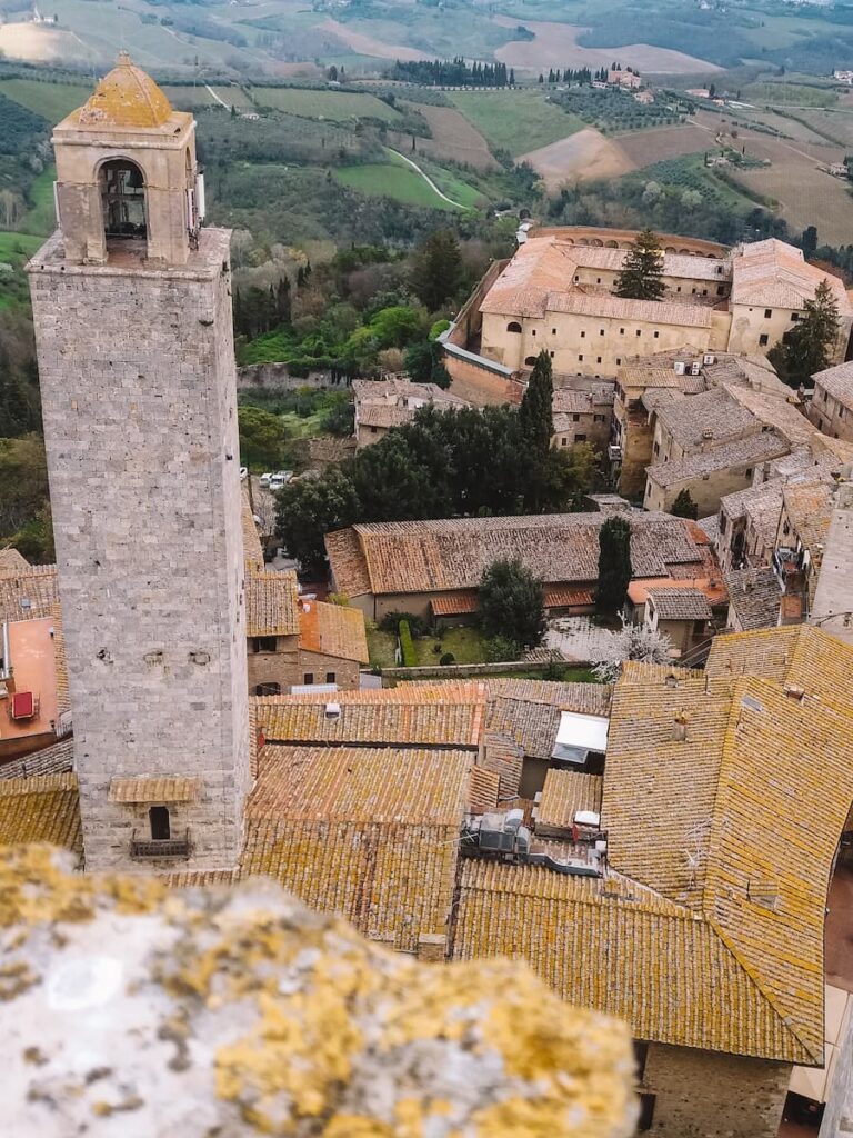Medieval towers and rooftops of San Gimignano overlooking the Tuscan countryside.