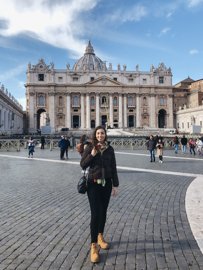 Woman standing in St. Peter's Square during a Vatican tour in Rome.
