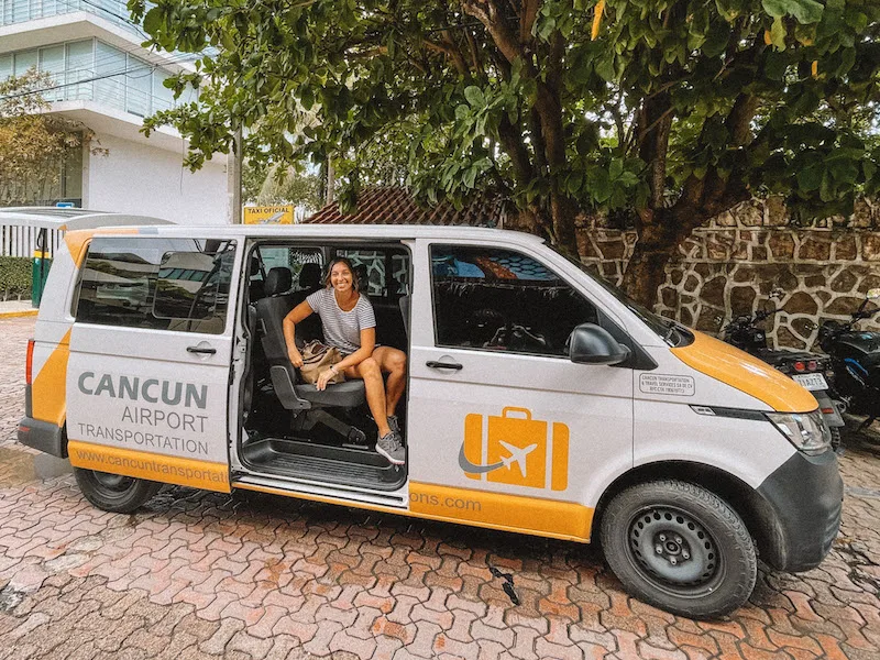 Woman smiling sitting inside a private transfer from Cacnun Airport to Tulum.