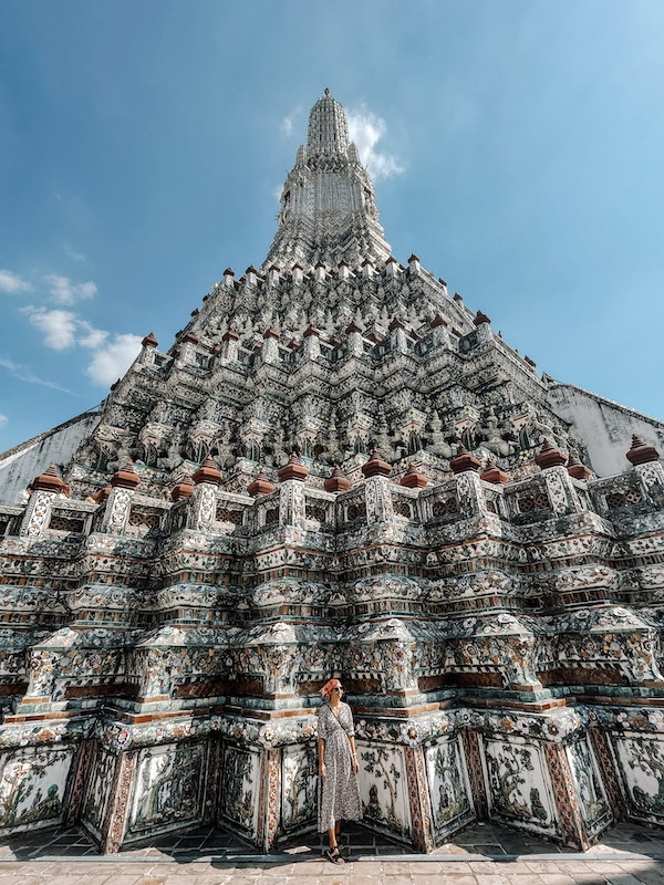 A woman posing in front of a temple in Wat Arun, inserted in a post about Bangkok tours