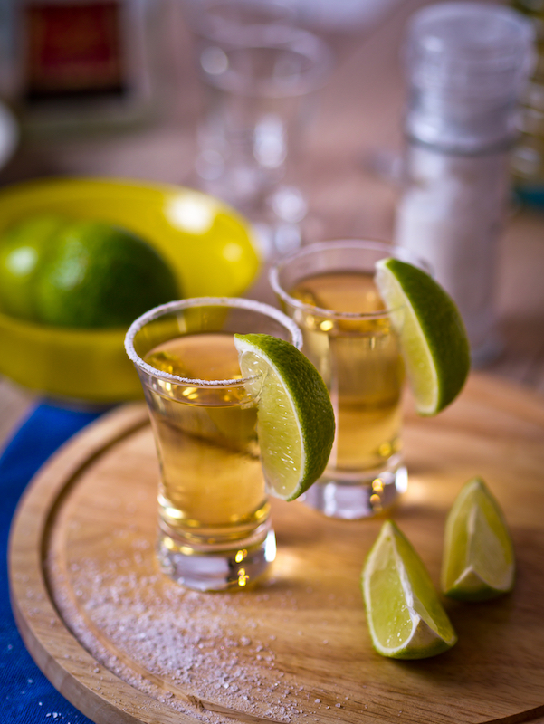 Two shots of tequila with salt and lime wedges on the side during a tequila tasting in Cabo San Lucas.