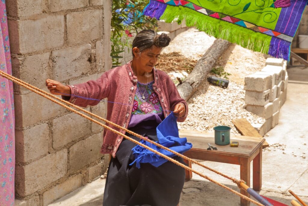 A woman weaving textiles in Zinacantan, inserted in a post about things to do in Chiapas