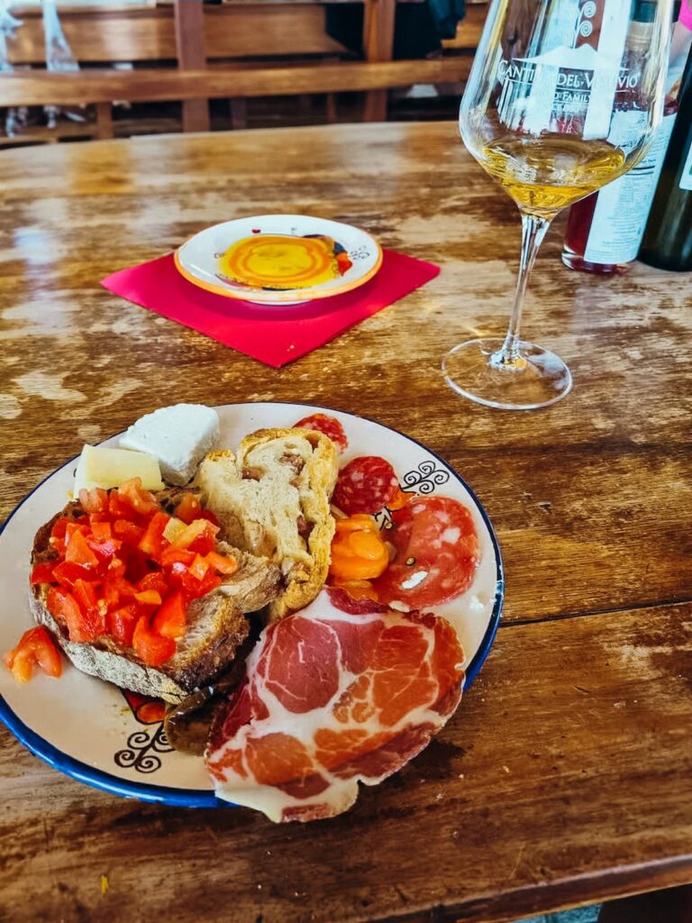 Wine tasting with local food pairings, including bruschetta, cured meats, and cheese.