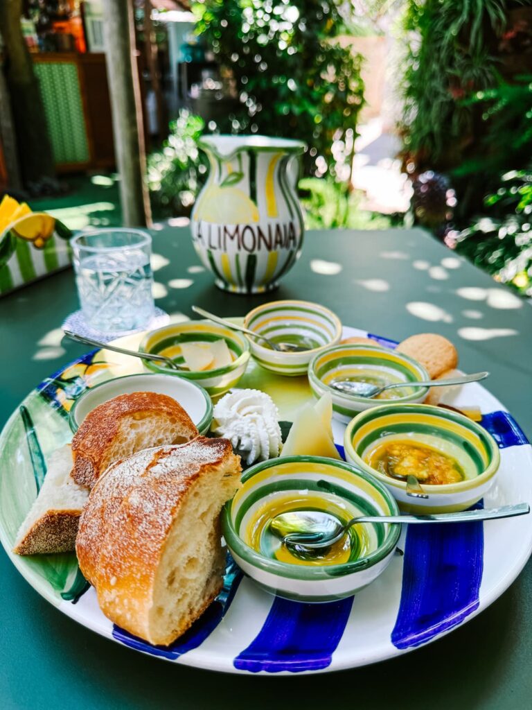 Tasting plate with lemon marmalade, bread, cheese, and limonata at a lemon garden in Sorrento.