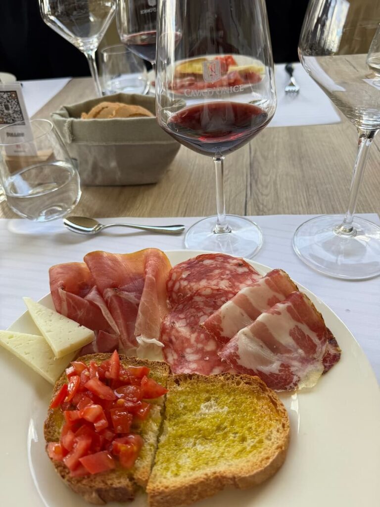 Tuscan cold cuts, cheese and bruschetta served with red wine during a tasting in Montalcino.