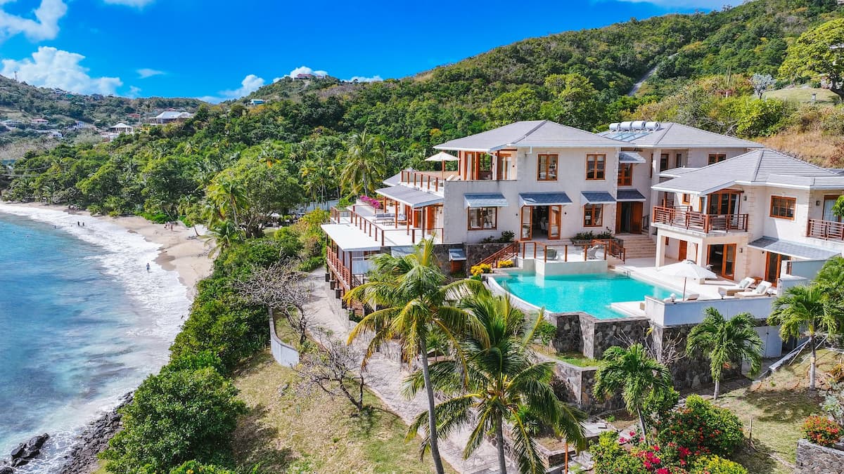 Seaside villa with a swimming pool and terraces, surrounded by palm trees on Bequia.