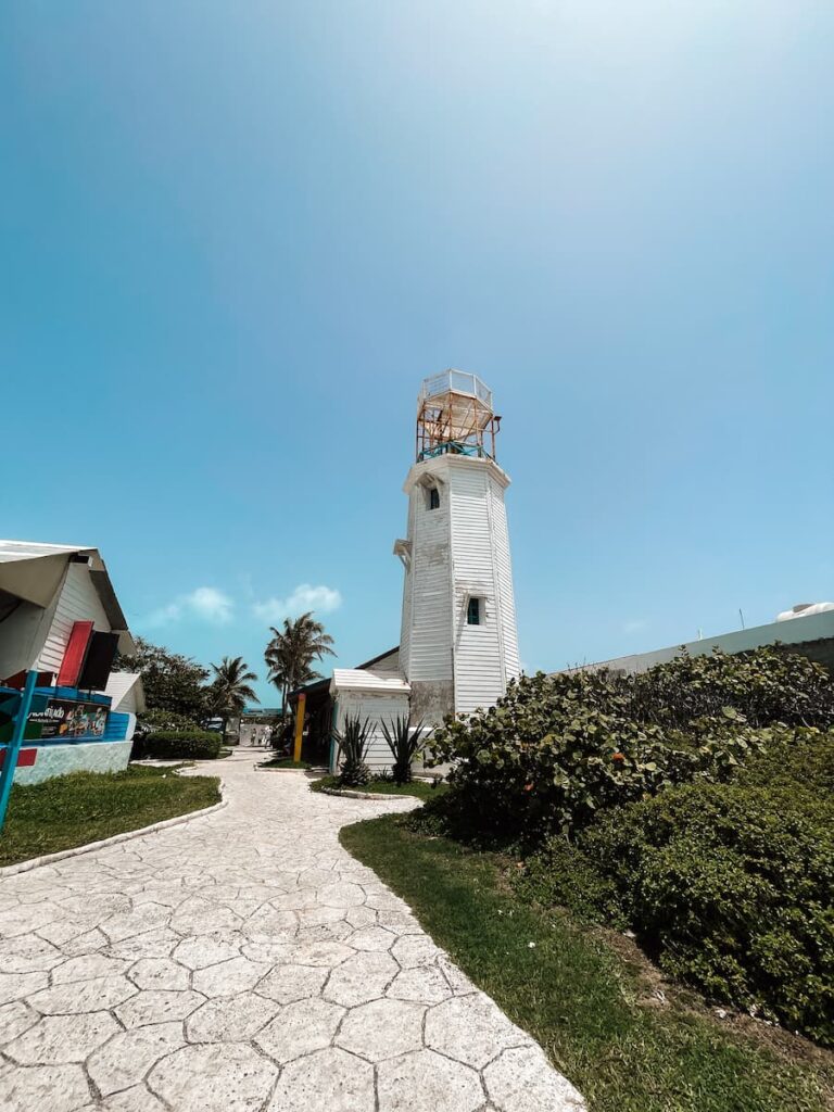 White lighthouse beside a paved path at Punta Sur on Isla Mujeres.