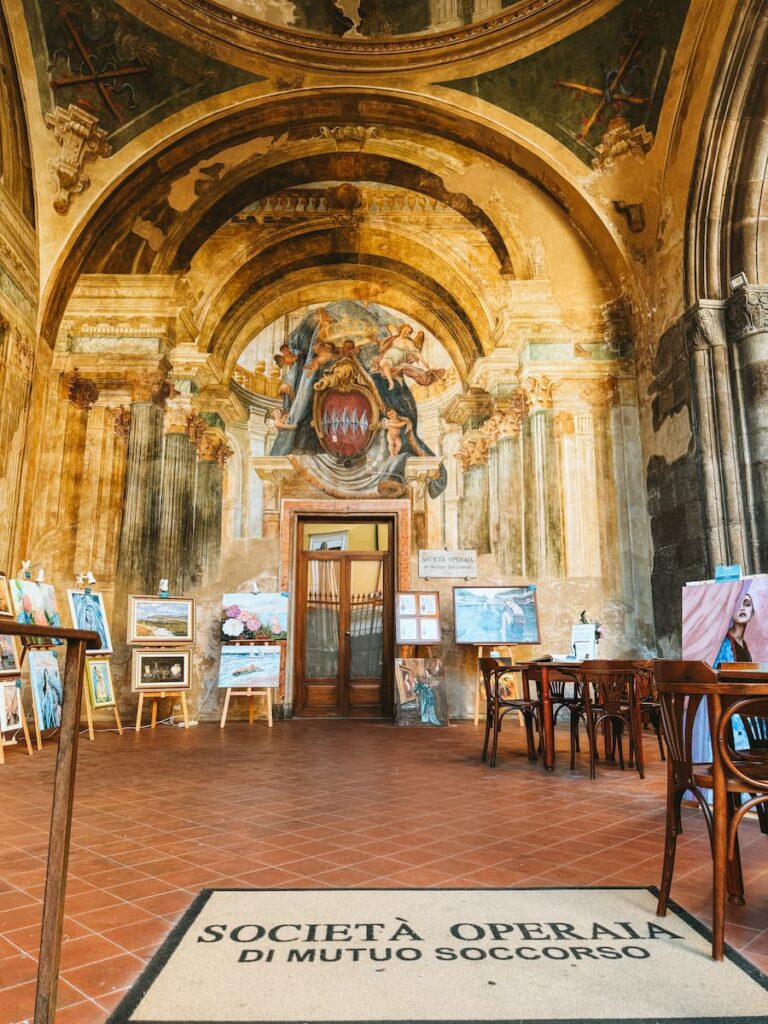 Frescoes and painted arches inside Sedile Dominova in Sorrento.